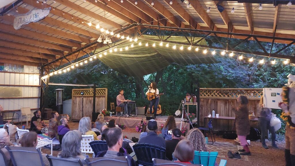 Evening stage performance at farmstand market